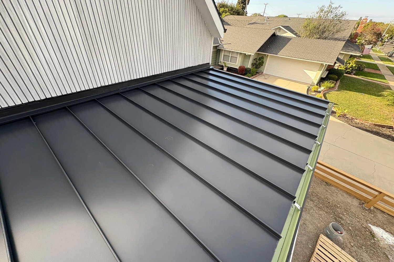 A standing seam metal roof part way through installation