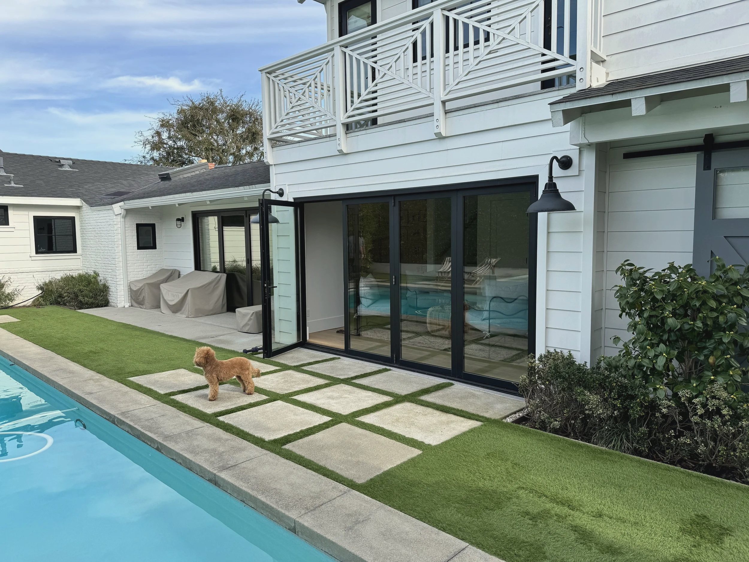 Bi-fold doors opening a Costa Mesa house to its patio and pool