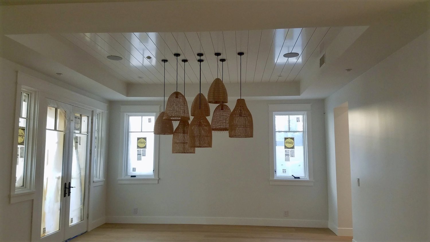 A boarded tray, and five pendants under it