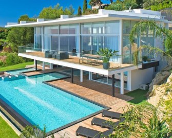 Rendering of the finished house seen from below, glass walls above the pool terrace.