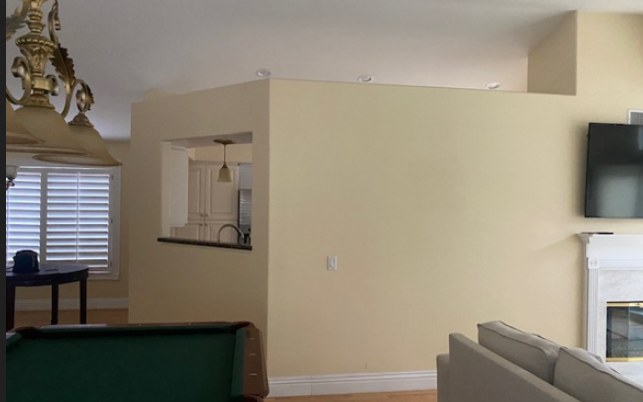 Before work began, the dividing wall that closed the kitchen off from the living room.