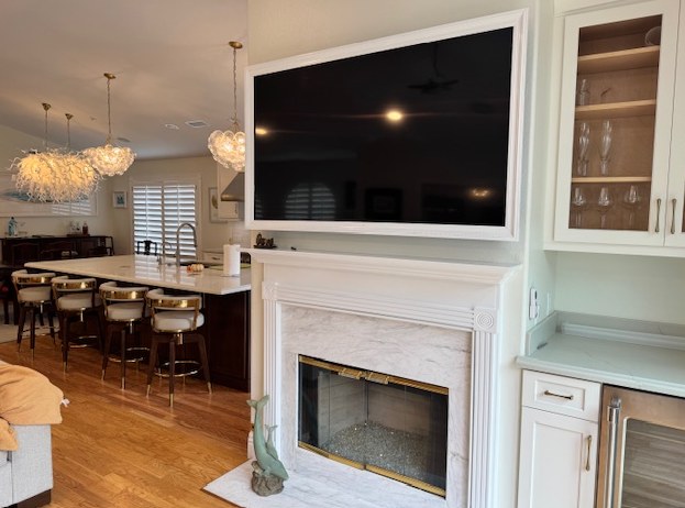 The fireplace wall before work, and the view through to the original kitchen and its bar seating.