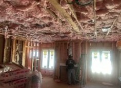 Insulation going into the open ceiling and walls during the remodel.
