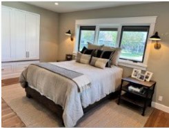 The finished bedroom, built-in wardrobes and wall sconces either side of the bed.