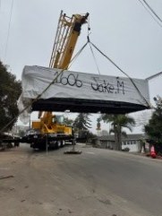 The container pool lifted clear of the street on the crane.