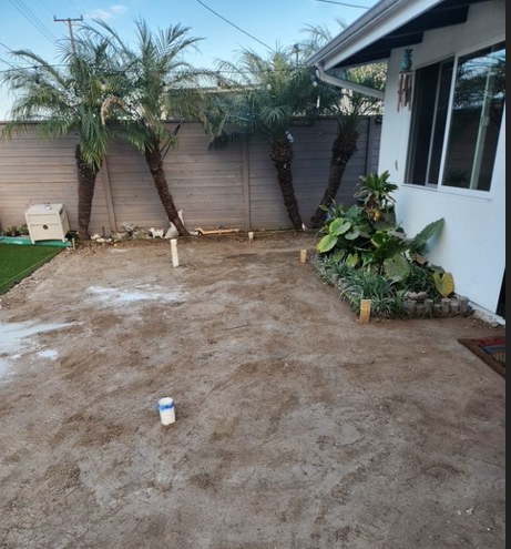 The back yard cleared to dirt before the new pool was set out.