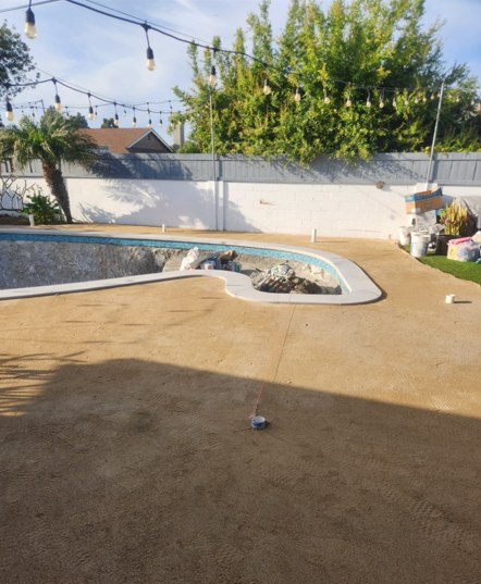 The new pool shaped and the yard graded, before the deck went down.
