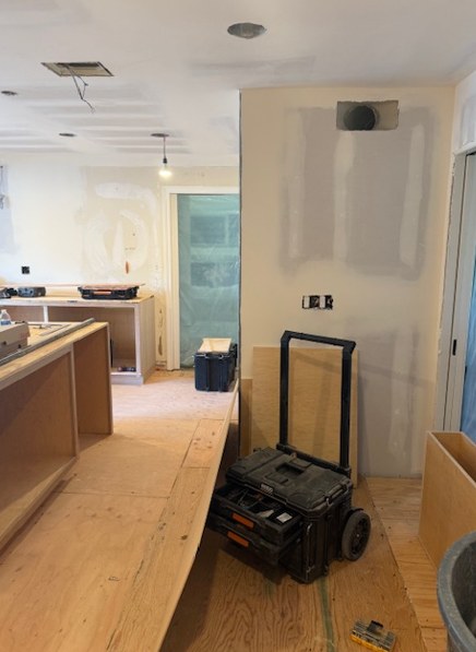 The room at drywall stage, with the island boxes set out.