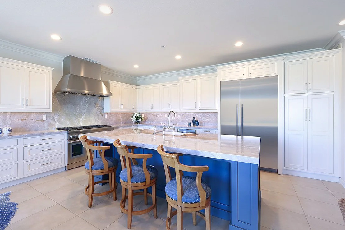 A San Clemente kitchen remodel, a blue island under a vaulted ceiling